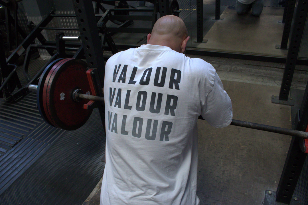 man barbell rowing in valour shirt