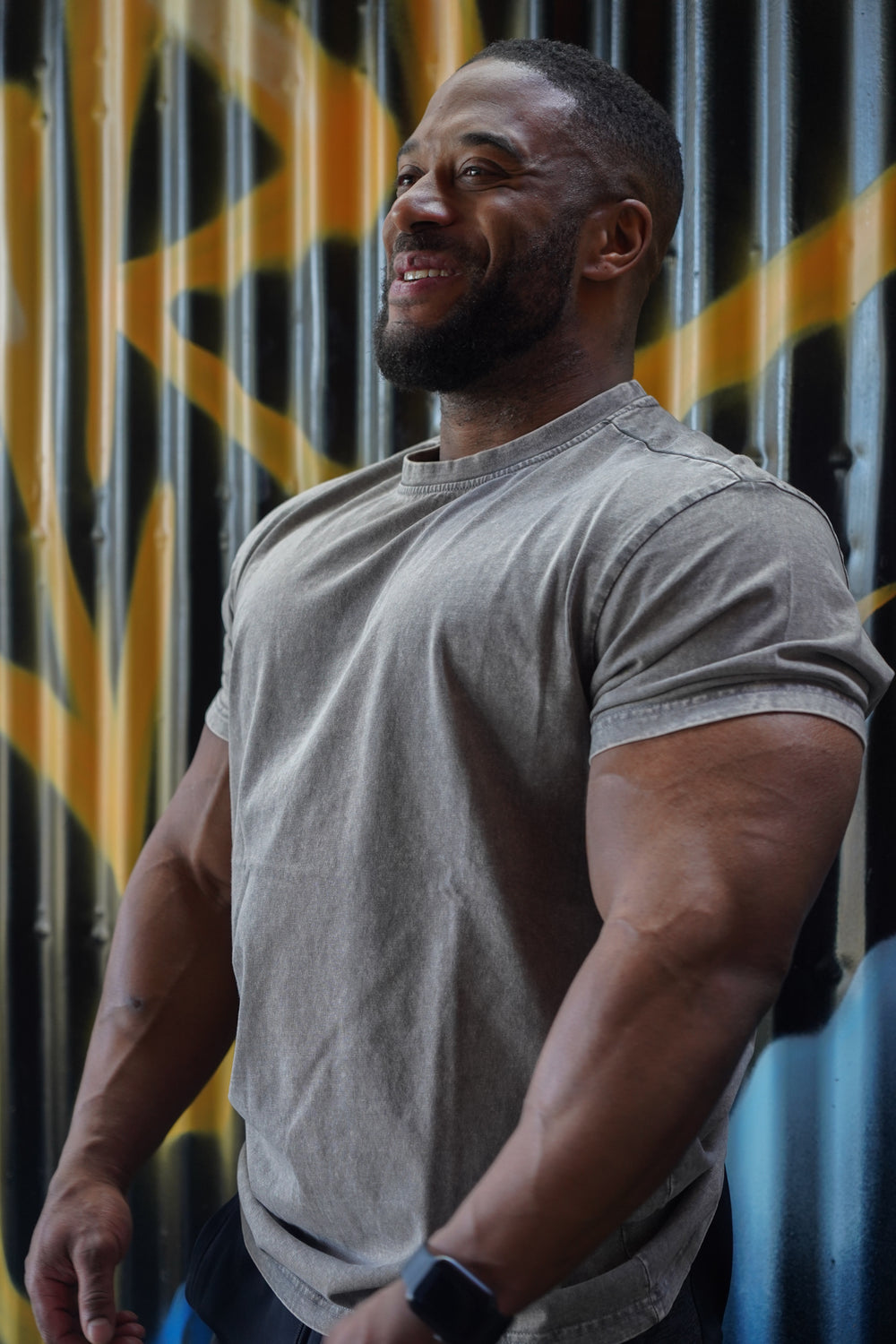 muscular man wearing grey valour gym shirt