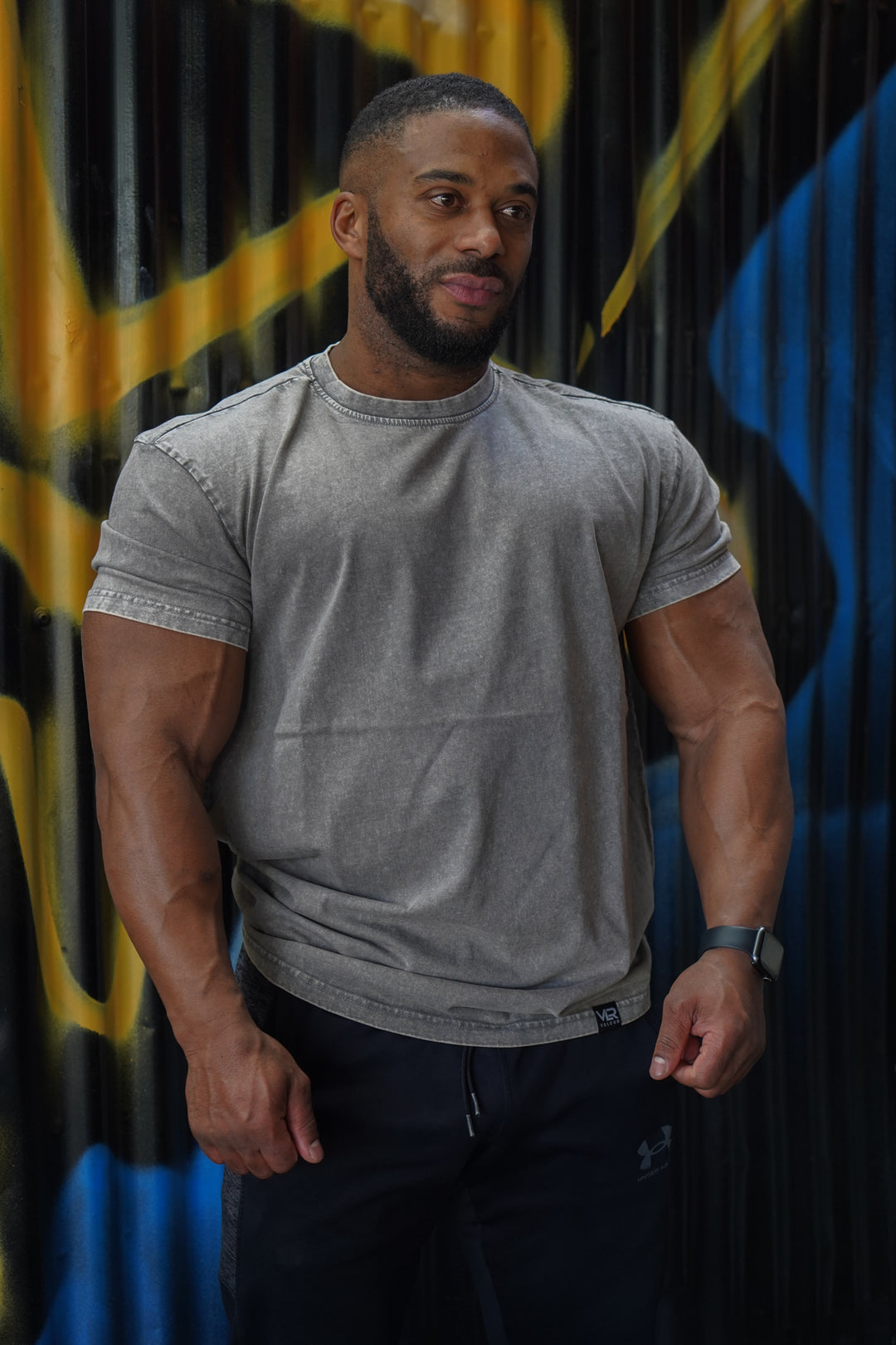 muscular man wearing grey valour gym shirt