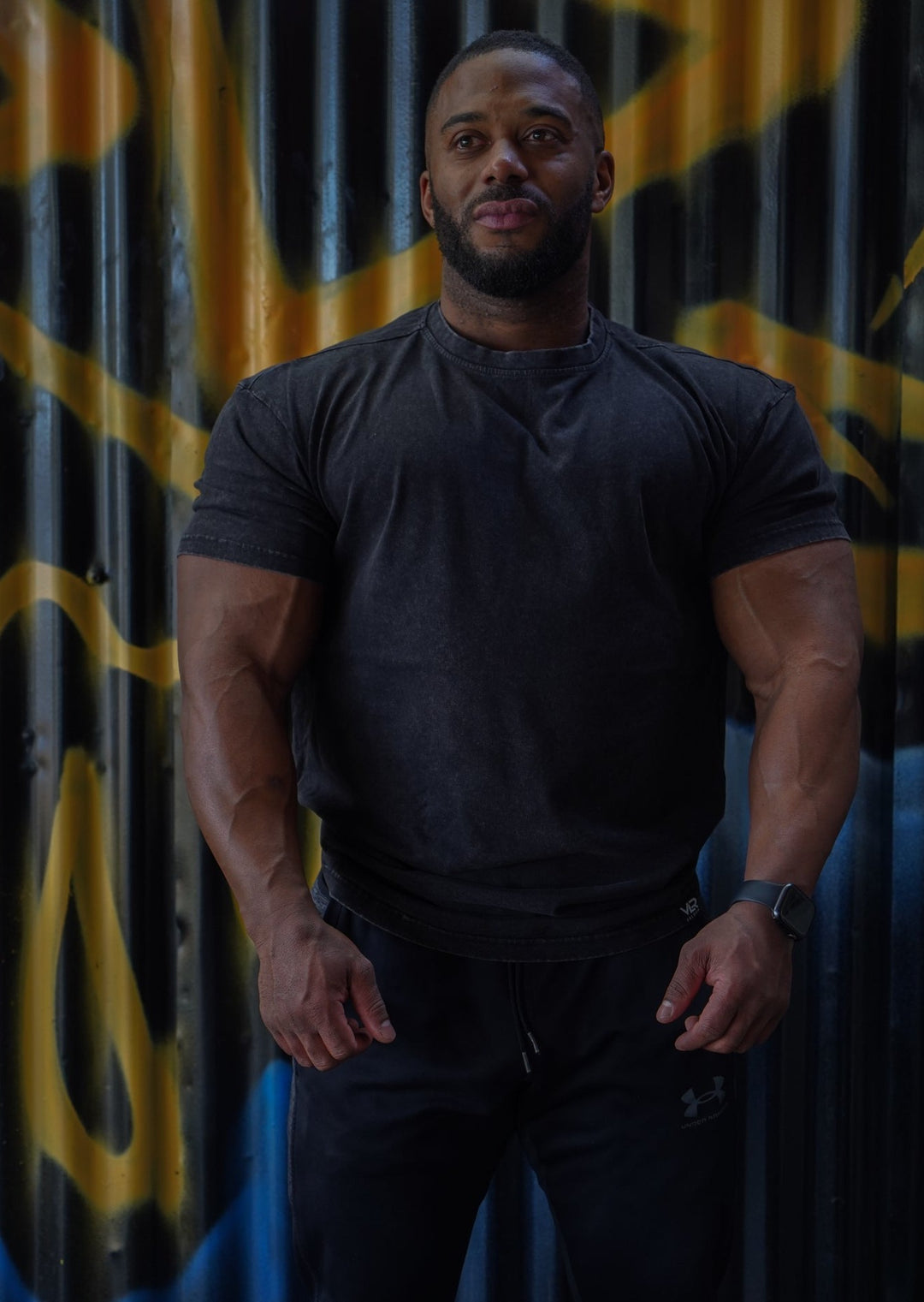 muscular man wearing black valour gym shirt