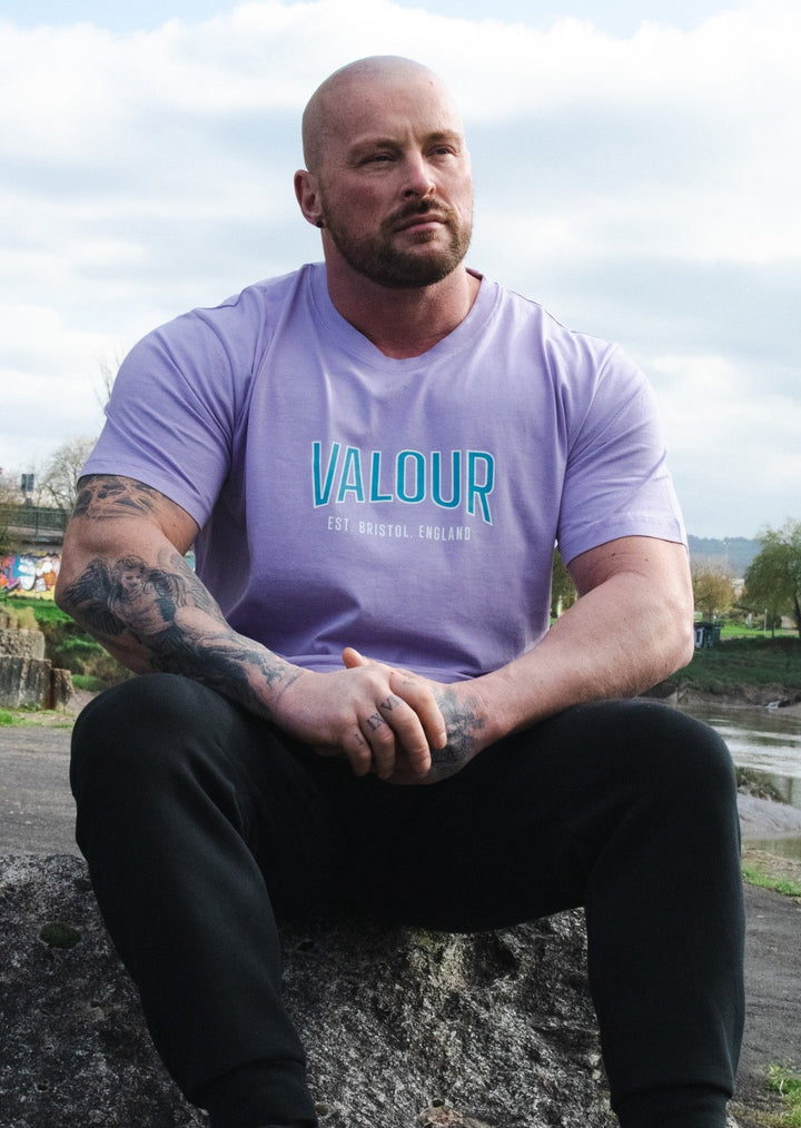 man wearing purple valour gym shirt