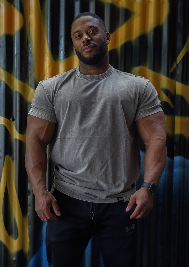 muscular man wearing grey valour gym shirt