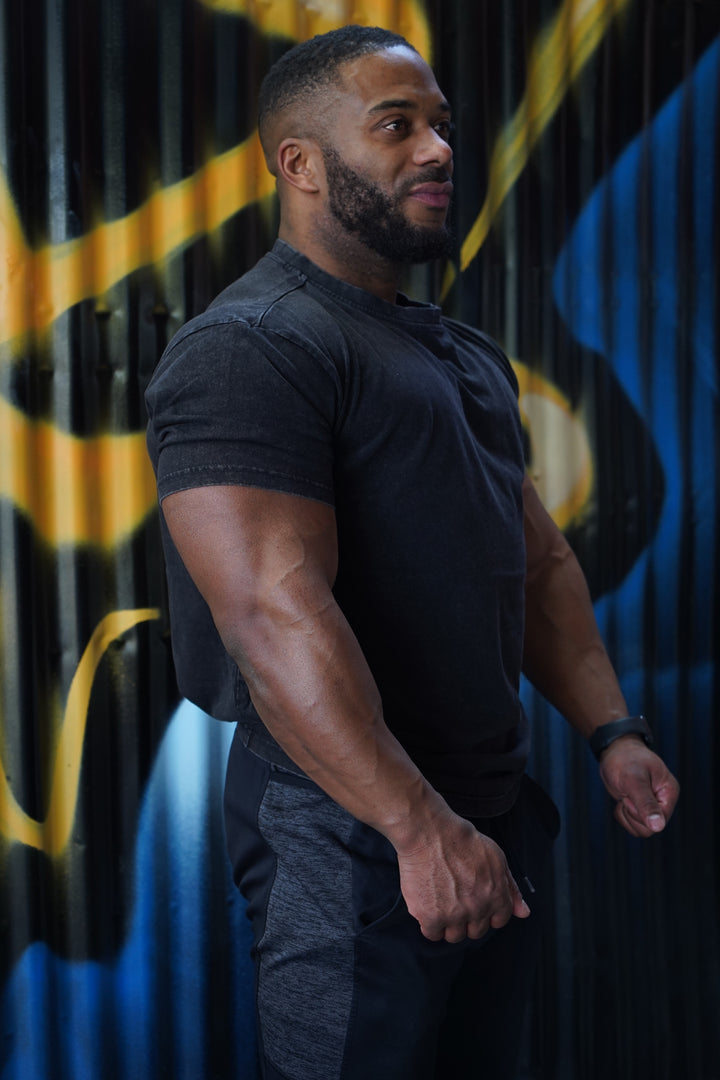 muscular man wearing black valour gym shirt